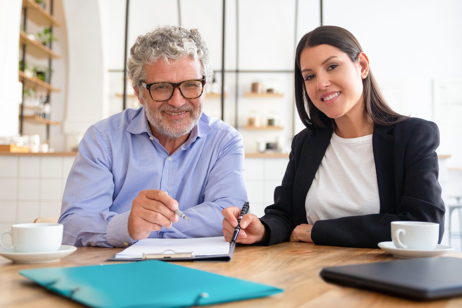 An advisor reviewing documents with a client across a table